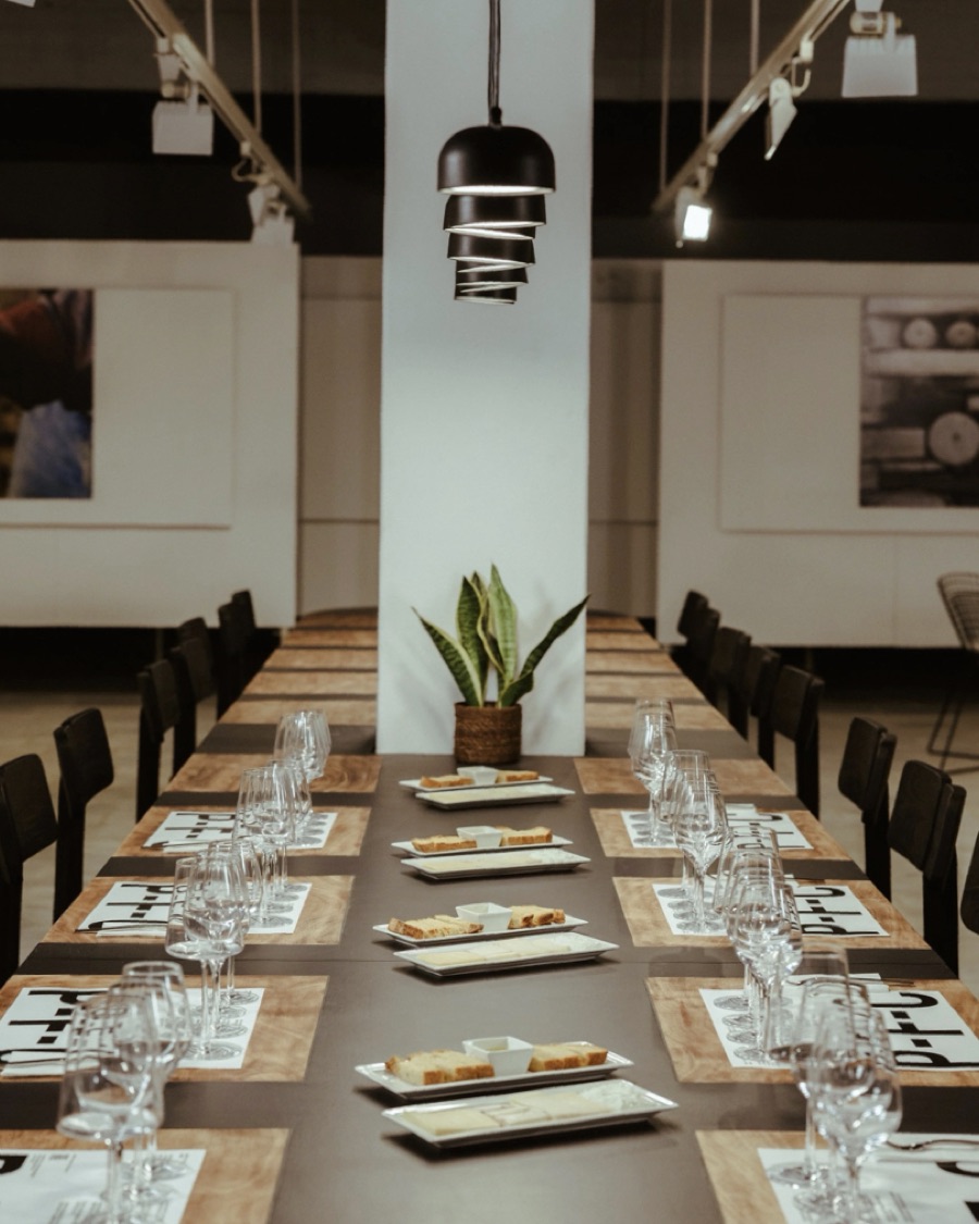 The long tasting table at Paros Farming Community, set with glasses, bread and cheese